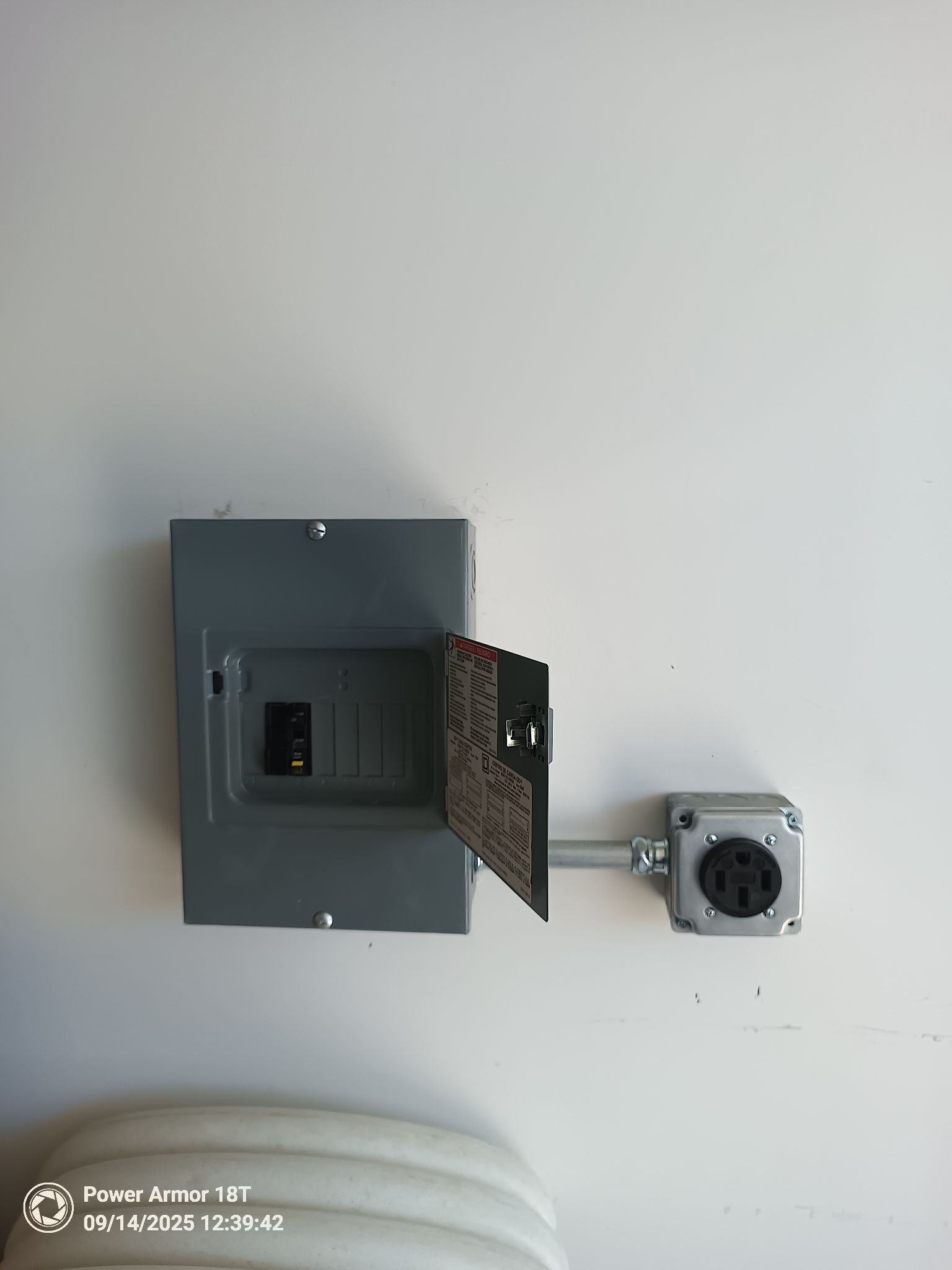 Open electrical panel connected to a nearby receptacle