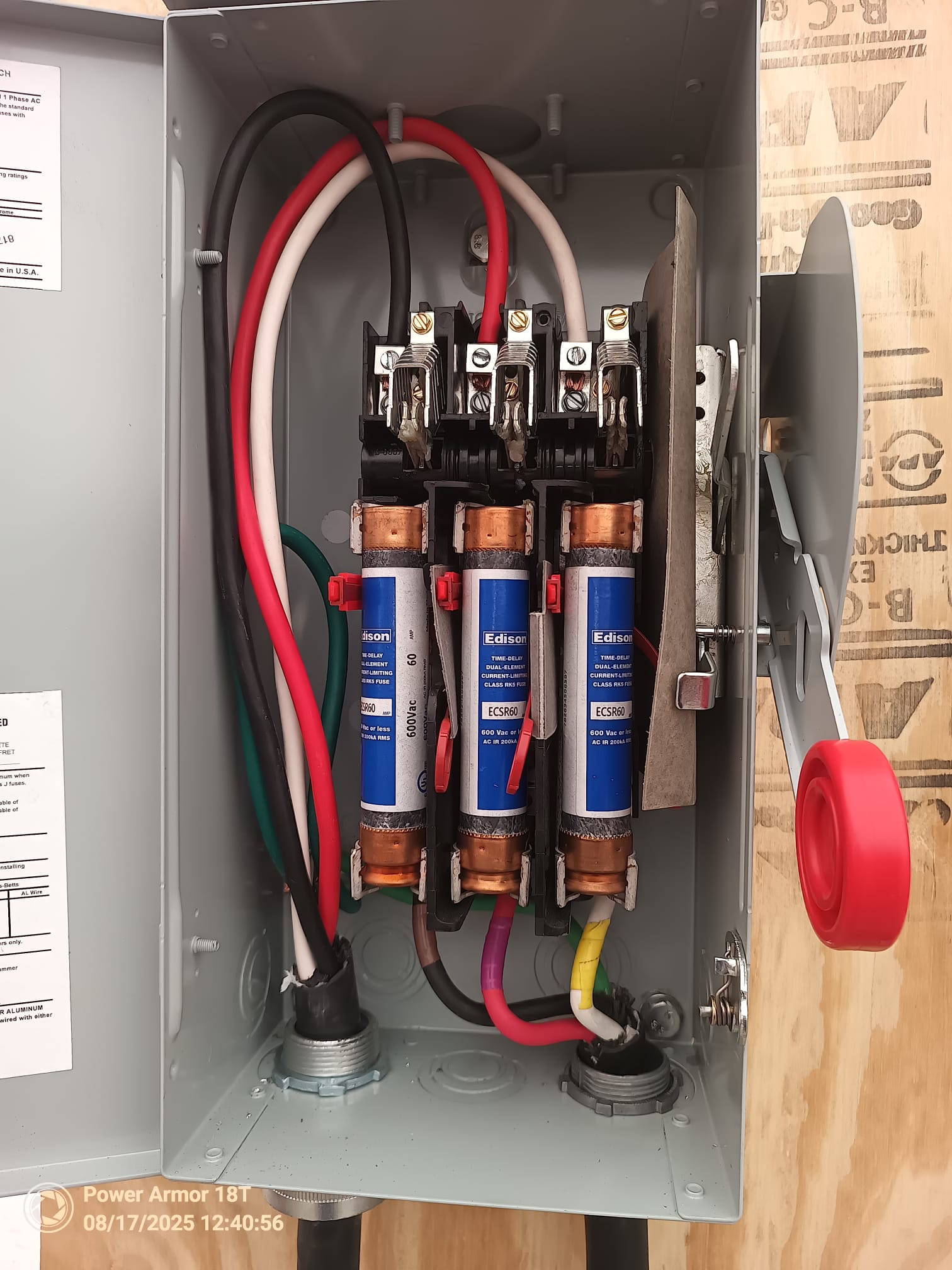 Connected cartridge fuses and wiring inside an open Eaton fused disconnect
