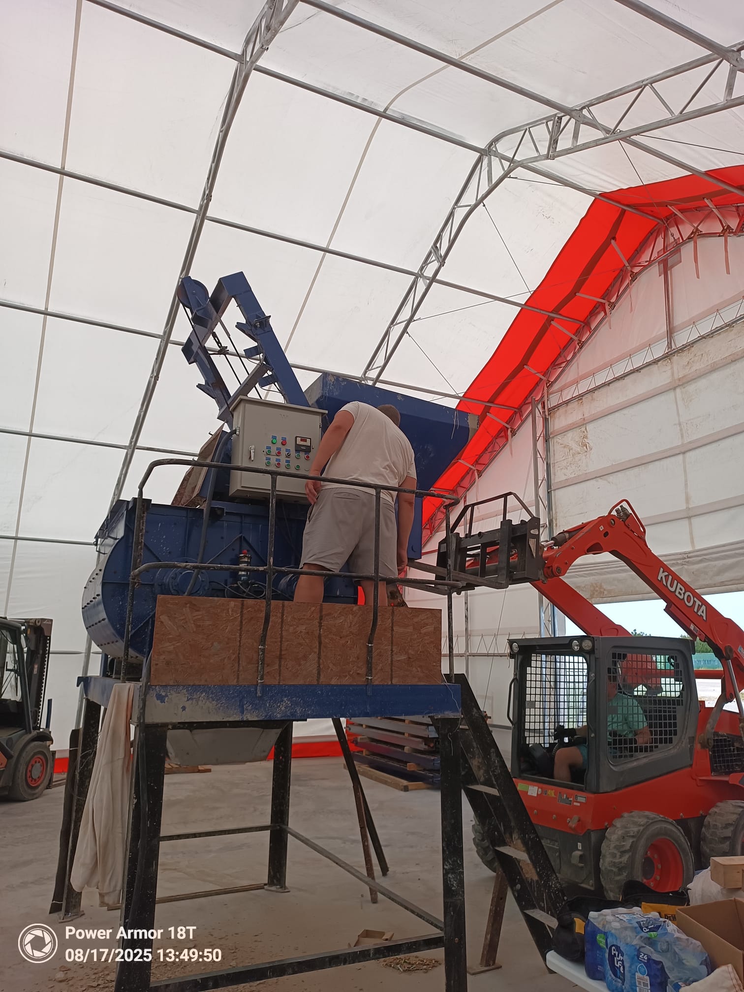Work on an equipment control panel inside a covered worksite