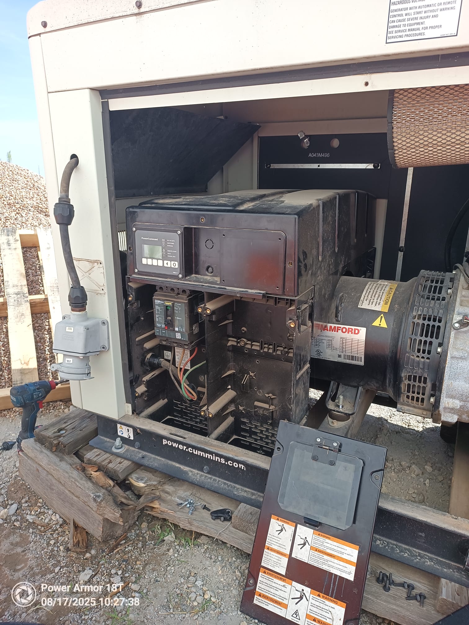 Open Cummins generator enclosure showing the control panel, circuit breaker and electrical connections