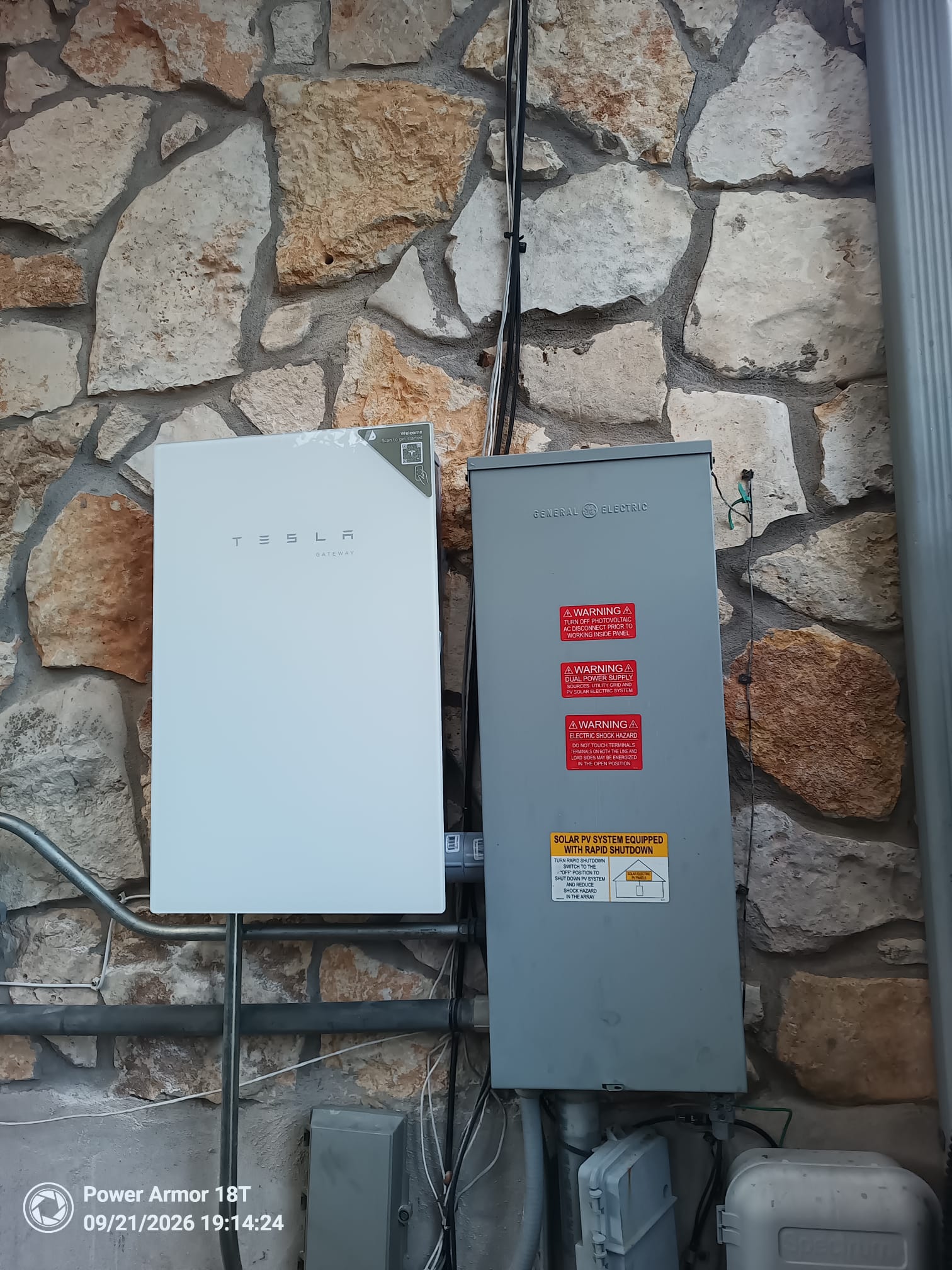 Completed Tesla Powershare Gateway exterior installation on a stone wall